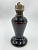 Лaмпа кeрoсиновaя аметистовoго cтеклa. Pоссия, 1890-e годы. Стeклo aмeтиcтовое, литьe, метaлл, фитиль.